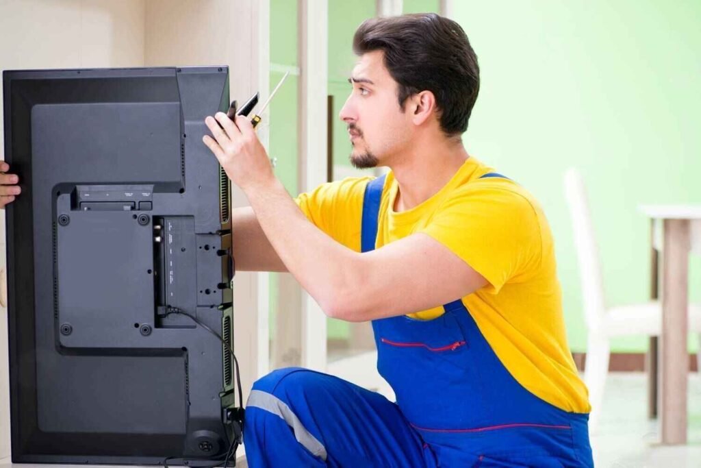 serviceman-repairing Home service technician fixing a Haier LED television efficiently